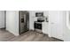 Modern kitchen with stainless steel appliances and white cabinets at 6359 S Forest Ave, Gilbert, AZ 85298