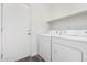A laundry room with a washer, dryer, and a door leading outside at 6359 S Forest Ave, Gilbert, AZ 85298