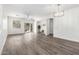 Bright, open living room with wood floors, ceiling fan, and sliding glass door to backyard at 6359 S Forest Ave, Gilbert, AZ 85298