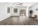 Bright, open living room with wood floors, ceiling fan, and sliding glass door to backyard at 6359 S Forest Ave, Gilbert, AZ 85298