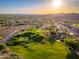 Picturesque aerial of a verdant golf course nestled among homes and desert terrain under a radiant sky at 6939 S Red Hills Rd, Gold Canyon, AZ 85118
