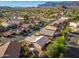 Expansive aerial view of a vibrant neighborhood showcasing homes with private pools and beautiful mountain scenery at 6939 S Red Hills Rd, Gold Canyon, AZ 85118