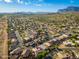 Scenic aerial shot of a neighborhood with well-maintained homes, streets, and distant mountain views at 6939 S Red Hills Rd, Gold Canyon, AZ 85118