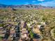 Expansive aerial view of a desert community, showcasing neighborhood layout and stunning mountain views at 6939 S Red Hills Rd, Gold Canyon, AZ 85118