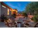 Beautiful backyard with a fire pit, seating area, desert landscaping, and outdoor grill at 6939 S Red Hills Rd, Gold Canyon, AZ 85118