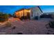 Spacious backyard with an outdoor seating area, fire pit, desert landscaping, and tasteful lighting at 6939 S Red Hills Rd, Gold Canyon, AZ 85118