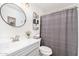 Well-lit bathroom with a round mirror, a sink with storage and a shower with curtain at 6939 S Red Hills Rd, Gold Canyon, AZ 85118