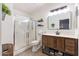Modern bathroom featuring a glass shower, a rustic vanity and ample shelving at 6939 S Red Hills Rd, Gold Canyon, AZ 85118
