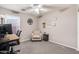 Comfortable home office with a ceiling fan, a decorative chair and a work desk at 6939 S Red Hills Rd, Gold Canyon, AZ 85118