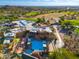 Aerial view of a luxurious golf clubhouse, pool, and surrounding green golf course at 6939 S Red Hills Rd, Gold Canyon, AZ 85118