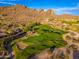 Expansive aerial view of a lush golf course set against a dramatic desert landscape and mountain range at 6939 S Red Hills Rd, Gold Canyon, AZ 85118