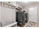 Functional laundry room with modern washer/dryer units and ample storage space at 6939 S Red Hills Rd, Gold Canyon, AZ 85118