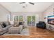 Bright living room with wood flooring, comfortable sofa, and sliding glass doors opening to a serene outdoor patio at 6939 S Red Hills Rd, Gold Canyon, AZ 85118