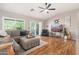 Cozy living room with wood floors, a comfortable sectional sofa, and a sliding door to the outdoor space at 6939 S Red Hills Rd, Gold Canyon, AZ 85118