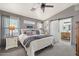 Comfortable main bedroom with soft carpet, natural light, and ensuite bathroom access via sliding barn door at 6939 S Red Hills Rd, Gold Canyon, AZ 85118