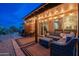 Inviting outdoor living space featuring stylish seating and a cozy ambiance with string lights for relaxed evenings at 6939 S Red Hills Rd, Gold Canyon, AZ 85118