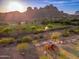 Aerial view of a playground with a colorful play set near a park and distant mountains at 6939 S Red Hills Rd, Gold Canyon, AZ 85118