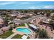 An aerial view showing a heart-shaped community pool with lounge chairs and well-maintained neighborhood landscaping at 713 W Boxelder Pl, Chandler, AZ 85225