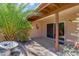 Backyard patio with landscaped rock garden, privacy wall, and covered seating area at 713 W Boxelder Pl, Chandler, AZ 85225