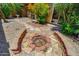 Backyard with a fire pit, rock landscaping, and a patio with mature landscaping at 713 W Boxelder Pl, Chandler, AZ 85225
