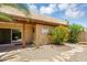 Backyard featuring rock landscaping, covered patio, and flowering shrubs at 713 W Boxelder Pl, Chandler, AZ 85225