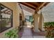 Close-up of a covered walkway featuring desert landscaping, decorative pillars, and textured walls at 713 W Boxelder Pl, Chandler, AZ 85225