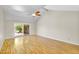 Open living room featuring vaulted ceilings, wood-look floors, and a sliding glass door to the backyard at 713 W Boxelder Pl, Chandler, AZ 85225