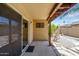 Outdoor patio with a sliding glass door, rock landscaping, and a covered area at 713 W Boxelder Pl, Chandler, AZ 85225