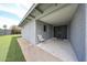 Cozy back patio with modern doors, smooth concrete, and artificial grass, perfect for outdoor relaxation at 7201 N 16Th Dr, Phoenix, AZ 85021