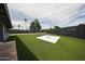 Lush backyard featuring an artificial grass lawn, privacy fencing, and space for recreation at 7201 N 16Th Dr, Phoenix, AZ 85021