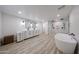 Modern bathroom featuring dual vanity, soaking tub, and frameless glass shower at 7201 N 16Th Dr, Phoenix, AZ 85021