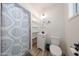 Small bathroom featuring a toilet, vanity, shelves and shower with curtain at 7201 N 16Th Dr, Phoenix, AZ 85021