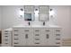 Bathroom vanity featuring double sinks, black hardware and modern lighting at 7201 N 16Th Dr, Phoenix, AZ 85021