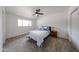 Bedroom featuring neutral carpet, ceiling fan, and window with a nightstand at 7201 N 16Th Dr, Phoenix, AZ 85021