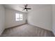Bedroom with neutral carpet, ceiling fan, window, and lots of natural light at 7201 N 16Th Dr, Phoenix, AZ 85021