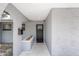 Covered front entrance featuring a modern black front door and decorative rock accents at 7201 N 16Th Dr, Phoenix, AZ 85021