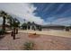 Well-maintained single-story home featuring mature desert landscaping and a long, circular driveway at 7201 N 16Th Dr, Phoenix, AZ 85021