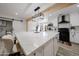 Modern kitchen with a large island, pendant lighting, white cabinets, and stainless appliances at 7201 N 16Th Dr, Phoenix, AZ 85021