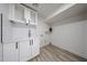Clean laundry area featuring modern white cabinets, stylish countertops, and tile backsplash with room for a washer/dryer at 7201 N 16Th Dr, Phoenix, AZ 85021