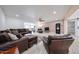 Open concept living room with hardwood floors, brick accent wall, ceiling fan, and comfortable furniture at 7201 N 16Th Dr, Phoenix, AZ 85021
