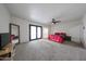 Spacious main bedroom featuring a ceiling fan, carpet flooring and access to the backyard at 7201 N 16Th Dr, Phoenix, AZ 85021