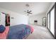 Large main bedroom featuring carpet, ceiling fan, neutral decor, and access to backyard at 7201 N 16Th Dr, Phoenix, AZ 85021