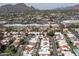 An aerial view showcasing the neighborhood featuring many houses with pools and beautiful mountain views at 7302 E Rose Ln, Scottsdale, AZ 85250