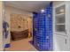 Stunning bathroom with a copper tub, stone accent wall, and a custom blue-tiled shower at 7302 E Rose Ln, Scottsdale, AZ 85250