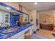 Unique bathroom with ornate mirrors, decorative blue tile, double sinks, and a luxurious copper bathtub at 7302 E Rose Ln, Scottsdale, AZ 85250