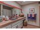 Nicely appointed bathroom featuring a decorative sink, vanity, and a mirror at 7302 E Rose Ln, Scottsdale, AZ 85250