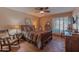Comfortable bedroom with a ceiling fan, shutters, and tile flooring at 7302 E Rose Ln, Scottsdale, AZ 85250