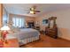 Charming bedroom with a bed, shuttered windows, dresser, and desk at 7302 E Rose Ln, Scottsdale, AZ 85250