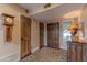 Hallway featuring wood doors, neutral paint, and a decorative rug at 7302 E Rose Ln, Scottsdale, AZ 85250