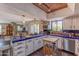 Bright kitchen with custom blue tile countertops, white cabinets, modern appliances and open floor plan to living room at 7302 E Rose Ln, Scottsdale, AZ 85250